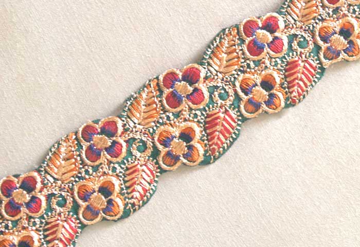 Trim with a floral design in satin stitch and chain stitch embroidery.